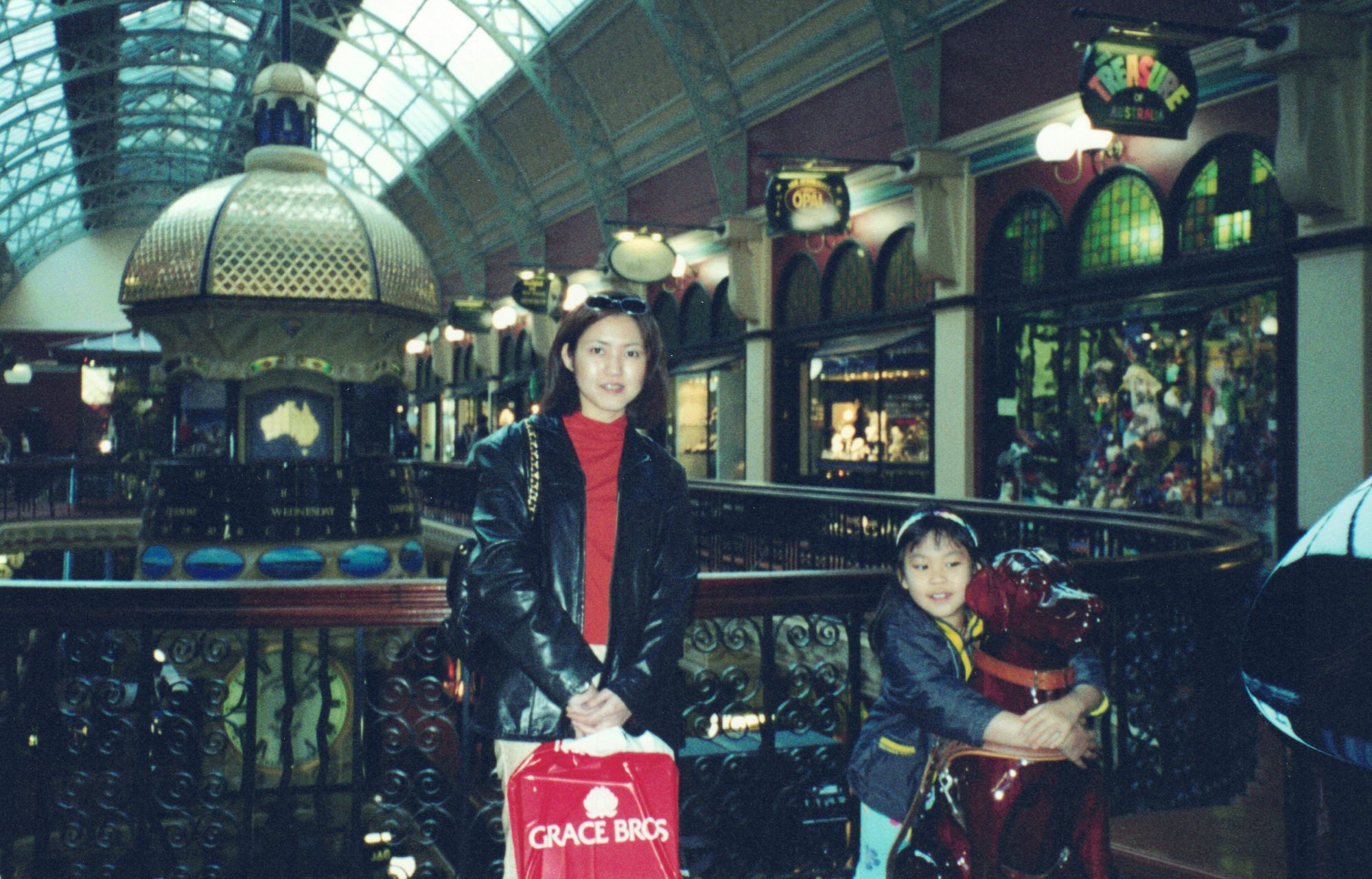 My mother and me on a bench inside an ornate Victorian shopping arcade