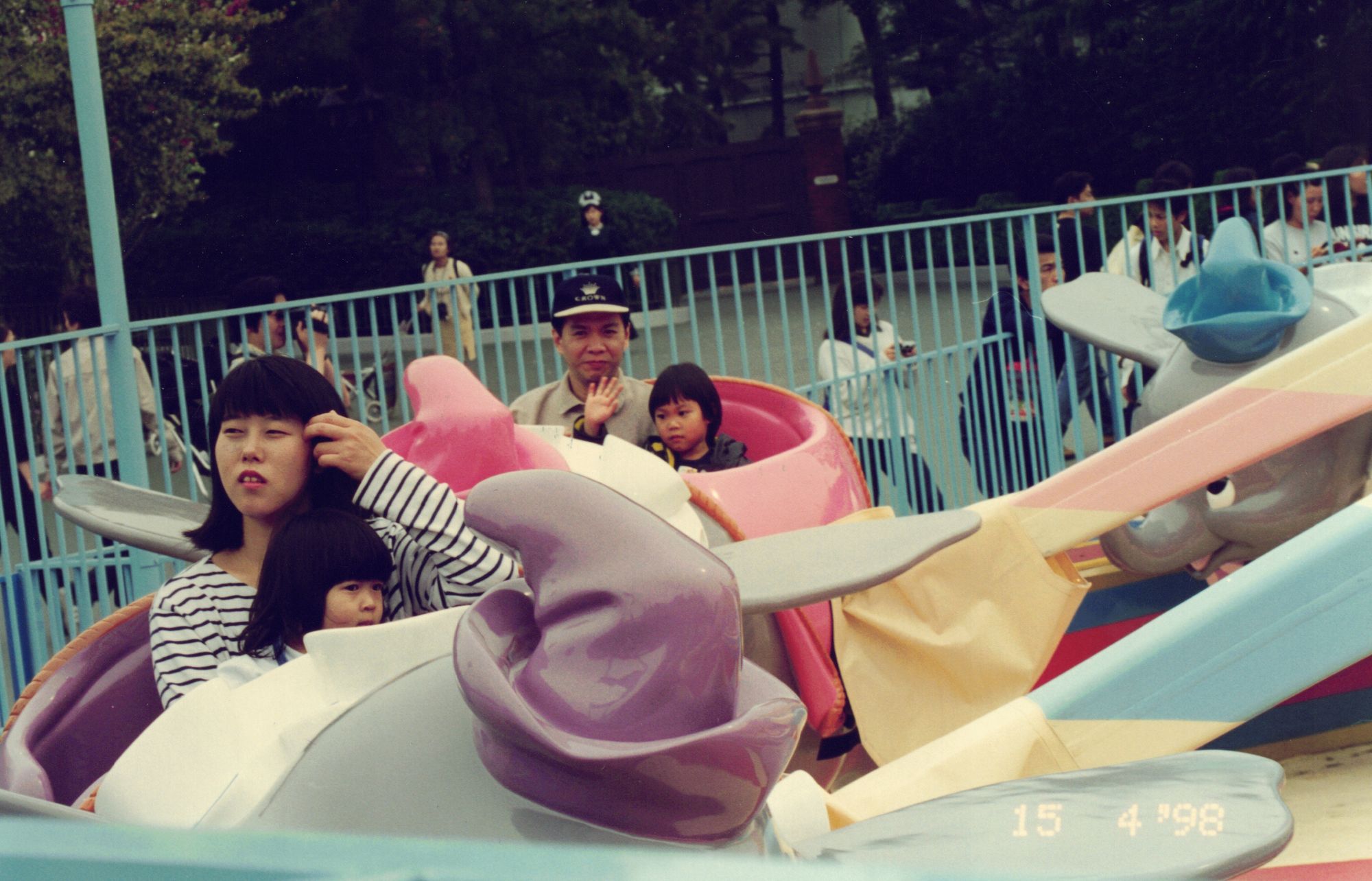My mother and me on a flying-elephant ride, the date stamped in the corner