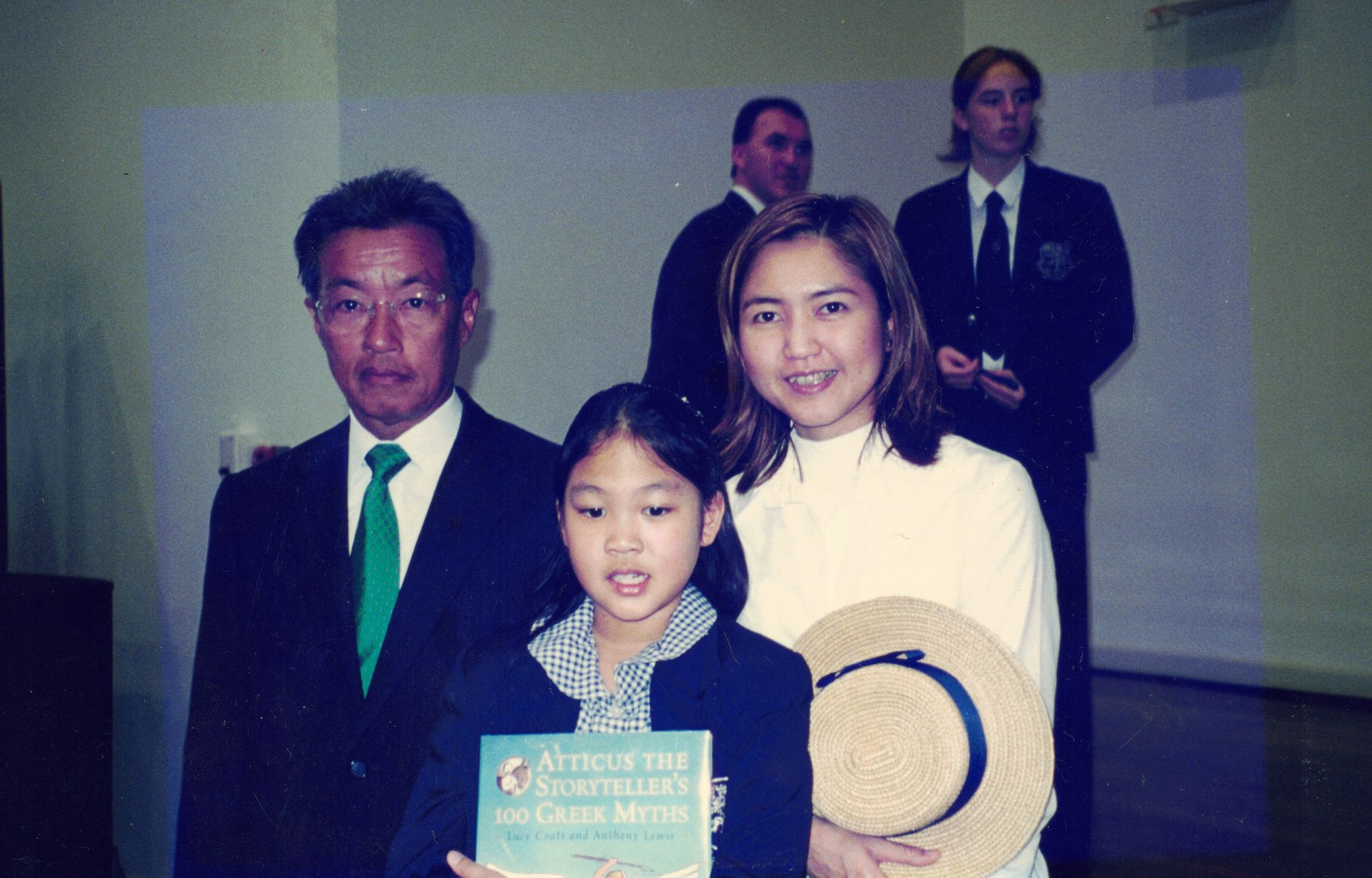 My parents and me at the Year 4 prize-giving; I am holding my prize book, my mother holds my boater
