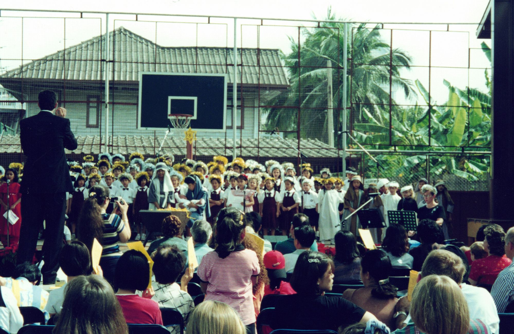 A school assembly on an outdoor court, seen from the audience