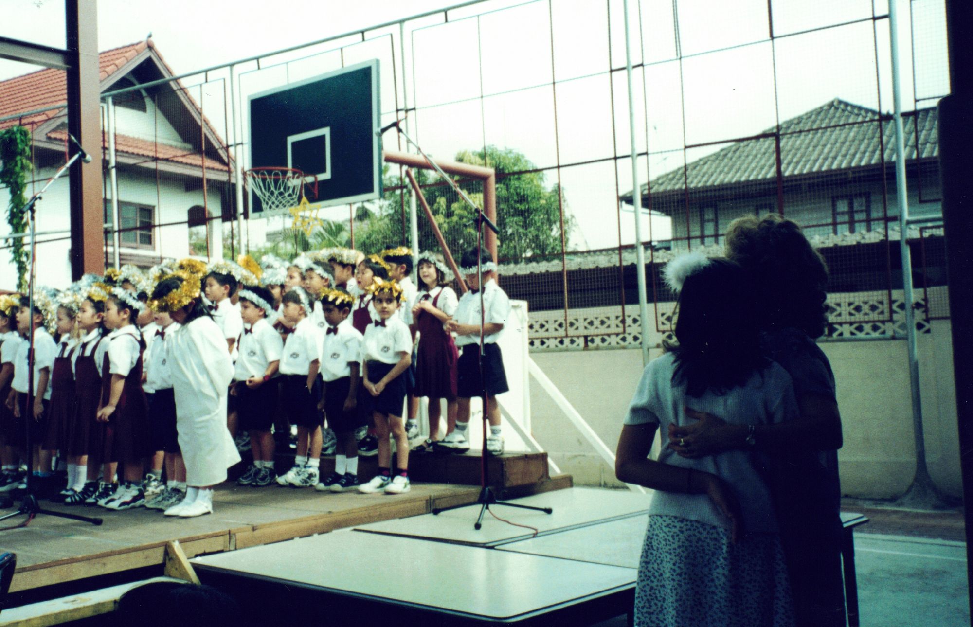 The same school performance seen wider, teachers watching from the side